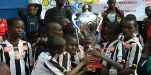 Children from the Acakoro Academy celebrate winning a football tournament 