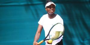 Angella Okutoyi prepares to serve the ball at a past tennis tournament.