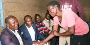 Kakamega governor Fernandes Barasa shakes hands with the late Isaac Juma's wife during the house handing over ceremony on December 11, 2022. 