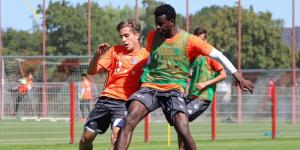 From left to right: German footballer Tim Haubler tackles Bernard Mwarome in a past Bayern Munich training session. 