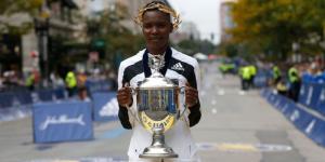 Kenyan runner Diana Kipyokei poses for a photo with the Boston Marathon trophy on Monday, October 11, 2021, in the United States.