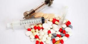 A sample of pills and drug syringes.