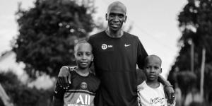 Men's marathon world record holder Eliud Kipchoge poses for a photo with his two sons.