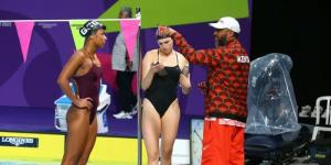 Kenyan swimmer Emily Muteti (L) receiving introductions from his coach (R) in a past competition.