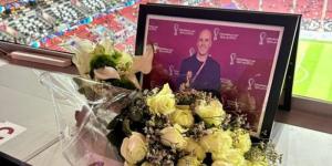 A framed photograph and bunch of flowers placed on the desk Grant Wahl would have used to cover the France versus England game on Saturday, December 10, 2022 at Al Bayt Stadium. 