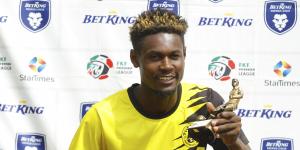 Tusker FC's Henry Meja displays his trophy