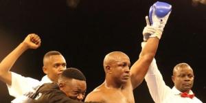 Tanzanian boxer Karim Mandonga (second from right) celebrates winning a previous fight. 
