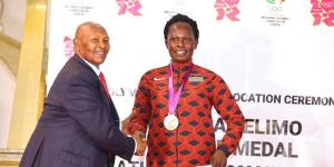 From left to right: IOC honorary member Kipchoge Keino awards Pamela Jelimo an Olympic bronze medal on December 7, 2022 in Nairobi.