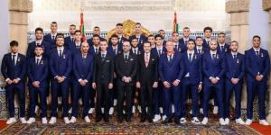 The Atlas Lions players pose for a photo alongside King Mohammed VI in Rabat on December 20, 2022. 