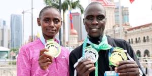 From left to right: Kenyan athletes Shelmith Nyawira Muriuki and Moses Kiptoo pose for a photo after winning the 2022 Kuala Lumpur Standard Chartered Half Marathon in Malaysia.