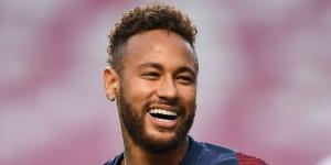 Neymar smiling during a football match. 