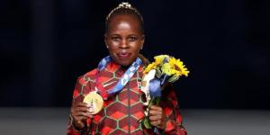 Road race runner Peres Jepchirchir poses for a photo with her Olympic medal on August, 2021 in Japan.