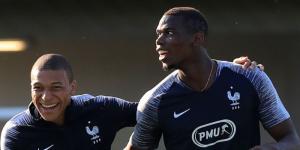 Kylian Mbappe (L) sharing a light moment with teammate Paul Pogba (R) during a past French national football team training session.