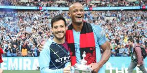 From left to right: David Silva (L) and Vincent Kompany (R) celebrating winning a FA Cup title during their time at Manchester City.