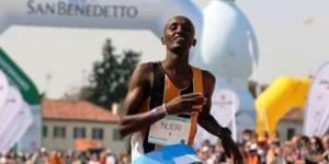 Kenyan runner Simon Kamau Njeri celebrates winning the Treviso Marathon on March 23, 2022 in Italy.