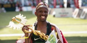 Tete Dijana posing with his award after wining the 2022 Comrades marathon held on August 28, in South Africa.