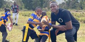 English rugby player Maro Itoje interacting with children in Nairobi, Kenya on July 25, 2022.