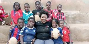 Mercy Migongo posing for a photo with some of the young girls who are part of the Kibera Golden Stars Rugby Program in Nairobi.
