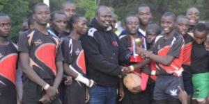 Vihiga players receive a trophy from KRU director Oscar Mango on June 29, 2022 after winning the Western Region Prescott title in a tournament held at Bungoma High School.
