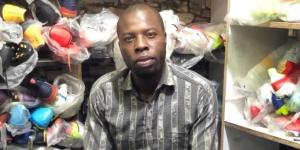 Simon Mwema poses for a photo at his shop Ronald Ngala Street in Nairobi