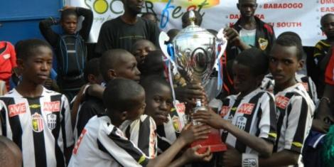 Children from the Acakoro Academy celebrate winning a football tournament 