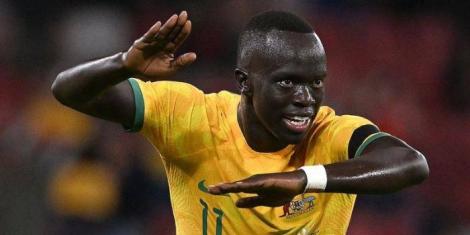 Kenyan-born winger Awer Mabil celebrates scoring a goal for Australia.