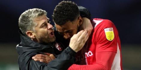 Kenyan international Jonah Ayunga being embraced by St. Mirren head coach Stephen Robinson during their time at Morecambe FC.