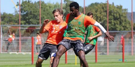 From left to right: German footballer Tim Haubler tackles Bernard Mwarome in a past Bayern Munich training session.