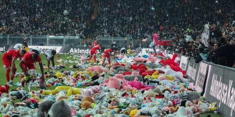 Players remove the thousands of toys donated by Besiktas fans to child earthquake survivors that hit Turkey earlier this month from the pitch on February 26, 2023, at the Vodafone Stadium.