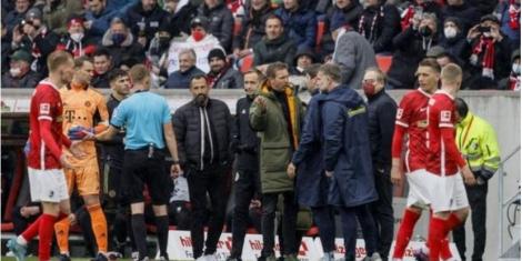 A file image of the referee and players from Bayern and Freiburg after the substitution mishap