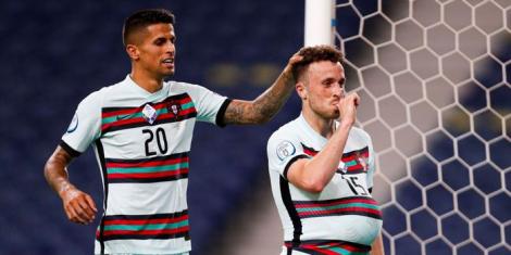 From left to right: Portuguese defender João Cancelo congratulates his teammate Diogo Jota for netting a goal in a past match.
