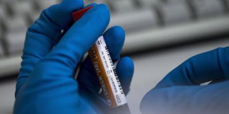 An image of a person holding a syringe.