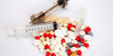 A sample of pills and drug syringes.