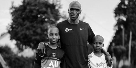 Men's marathon world record holder Eliud Kipchoge poses for a photo with his two sons.