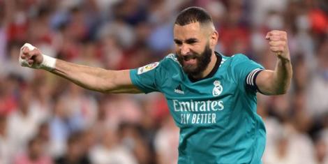 Real Madrid striker Karim Benzema celebrates a goal in a past match with his right hand bandaged.