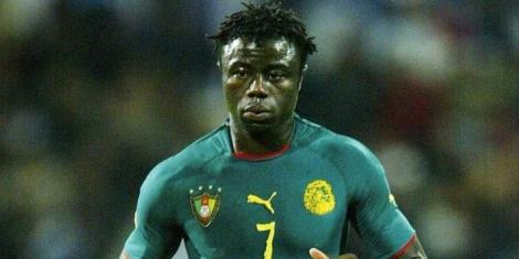 Former Cameroon midfielder Modeste M'Bami in action for Cameroon in a past match.