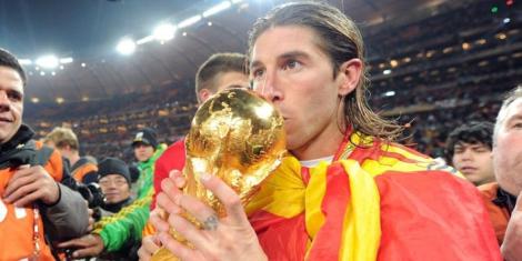 Spanish defender Sergio Ramos kisses the FIFA World Cup trophy after winning the 2010 edition at the Soccer City Stadium, in South Africa.