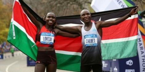 From left to right: Sharon Lokedi and Evans Chebet pose for a photo with Kenyan flag after winning the New York City Marathon titles on November 6, 2022.