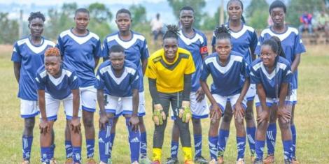 Trans Falcons players pose for a team photo before the start of a match.