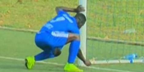 A player removing an object from the goal post in the Rwanda Premier League in 2015.