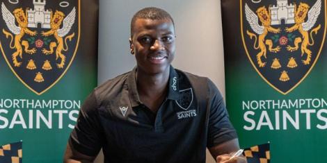 Kenyan teenager Josh Weru signing his professional contract with Northampton Saints Rugby Club in August, 2022.