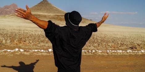 Lewis Hamilton posing for a photo at a tourist attraction site in Namibia on August, 2022.
