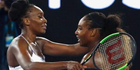 Venus Williams (L) embracing her younger sister Serana Williams (R) at the Australian Open Tennis Tournament on January 28, 2017.