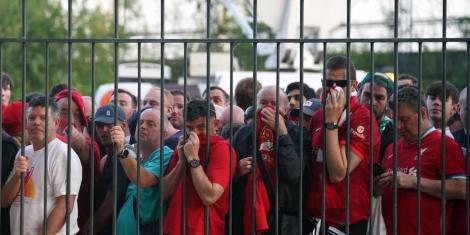 Liverpool fans covering their noses after French police fire teargas canisters at them at the State de France stadium on May 28, 2022.